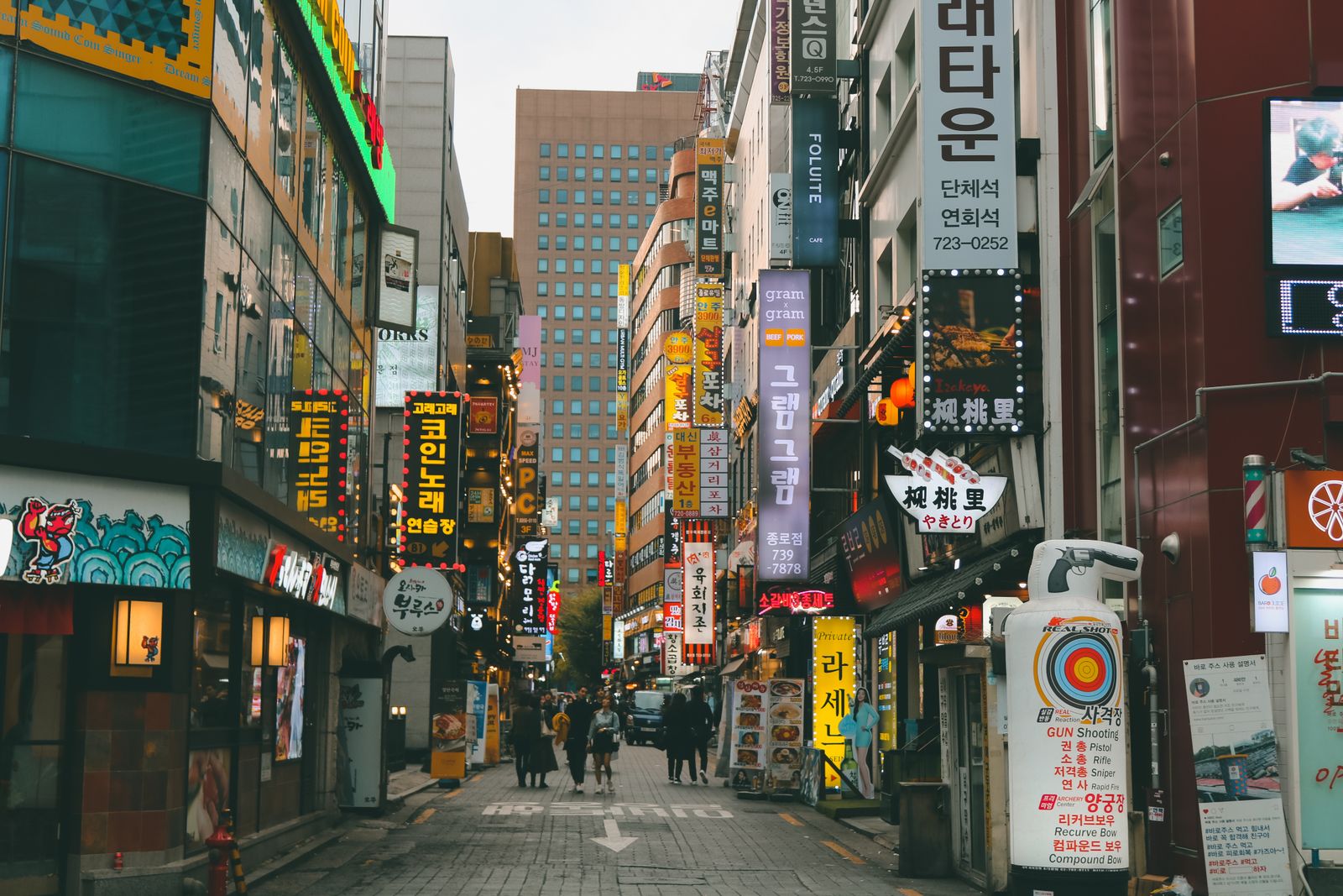 Where to Stay in Seoul: Best Neighborhoods for First-Time Visitors Lively street in Seoul lined with shops and signs