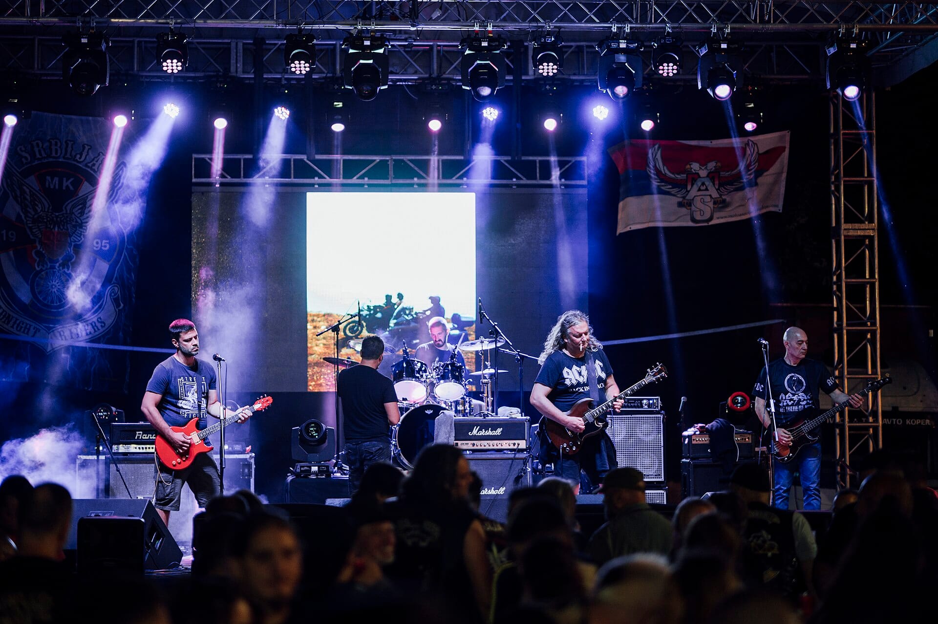 Crowd enjoying a live rock concert at an outdoor festival venue at night, the kind of scene the Busan International Rock Festival draws to Samnak Park