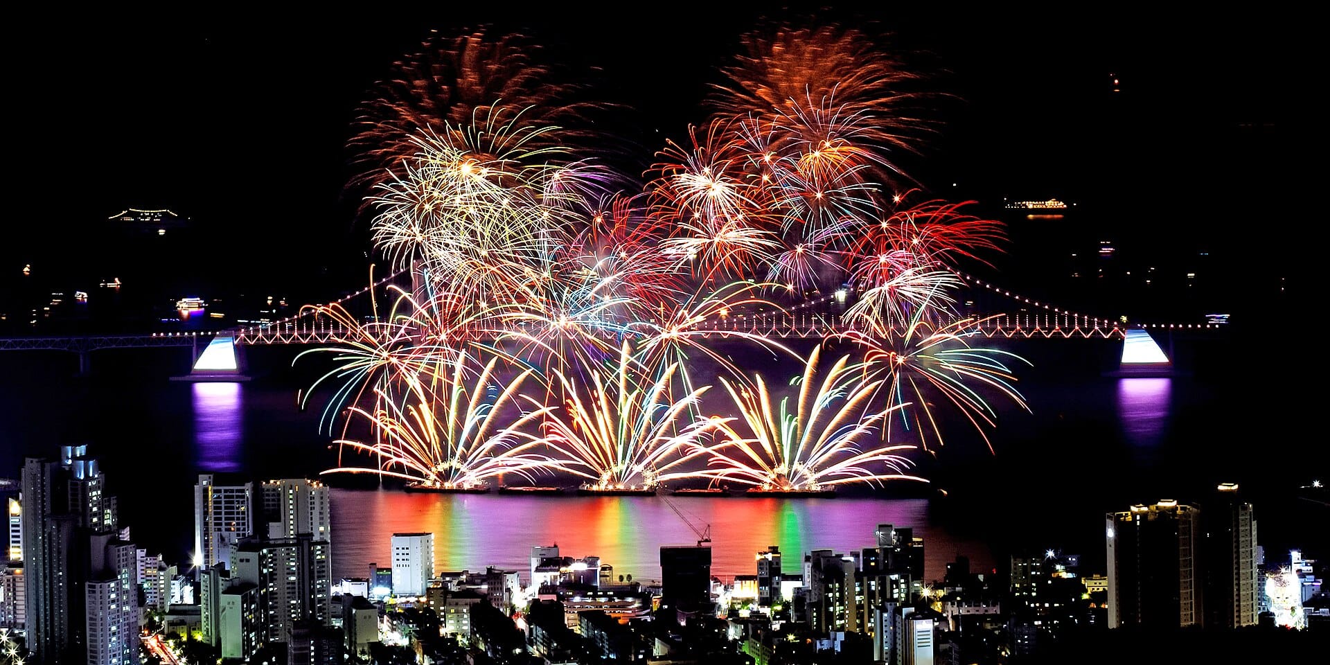 Fireworks lighting up the night sky over a Busan beach, the kind of closing show the Busan Sea Festival stages each night