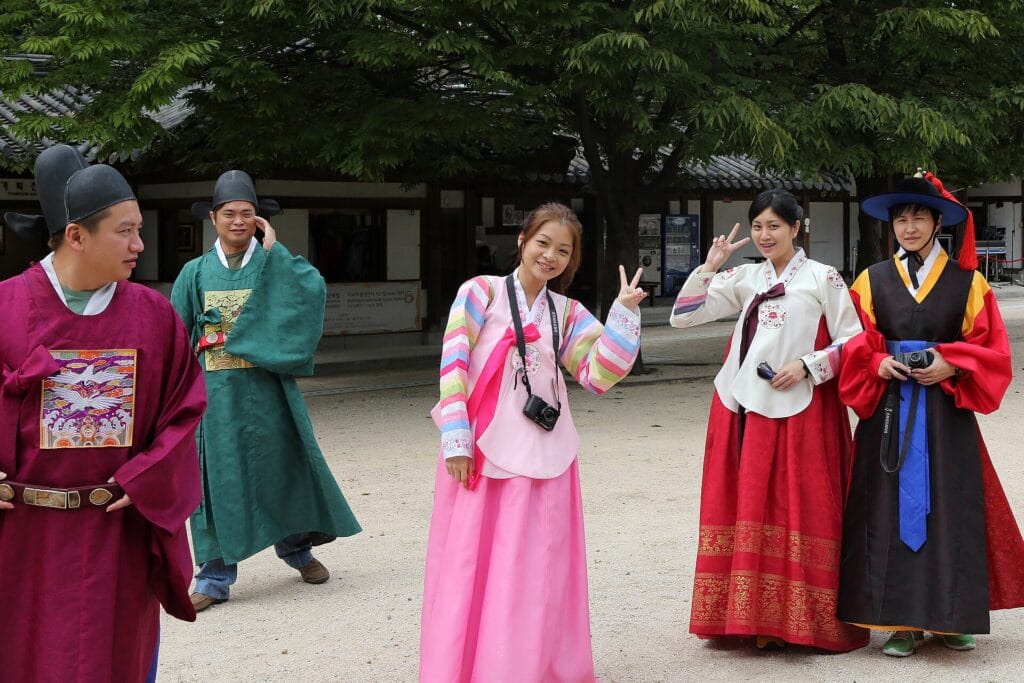 Chuseok 2026: Korea's Biggest Holiday — Dates, Closures & Travel Tips Visitors in traditional hanbok at a Seoul palace during a Korean holiday