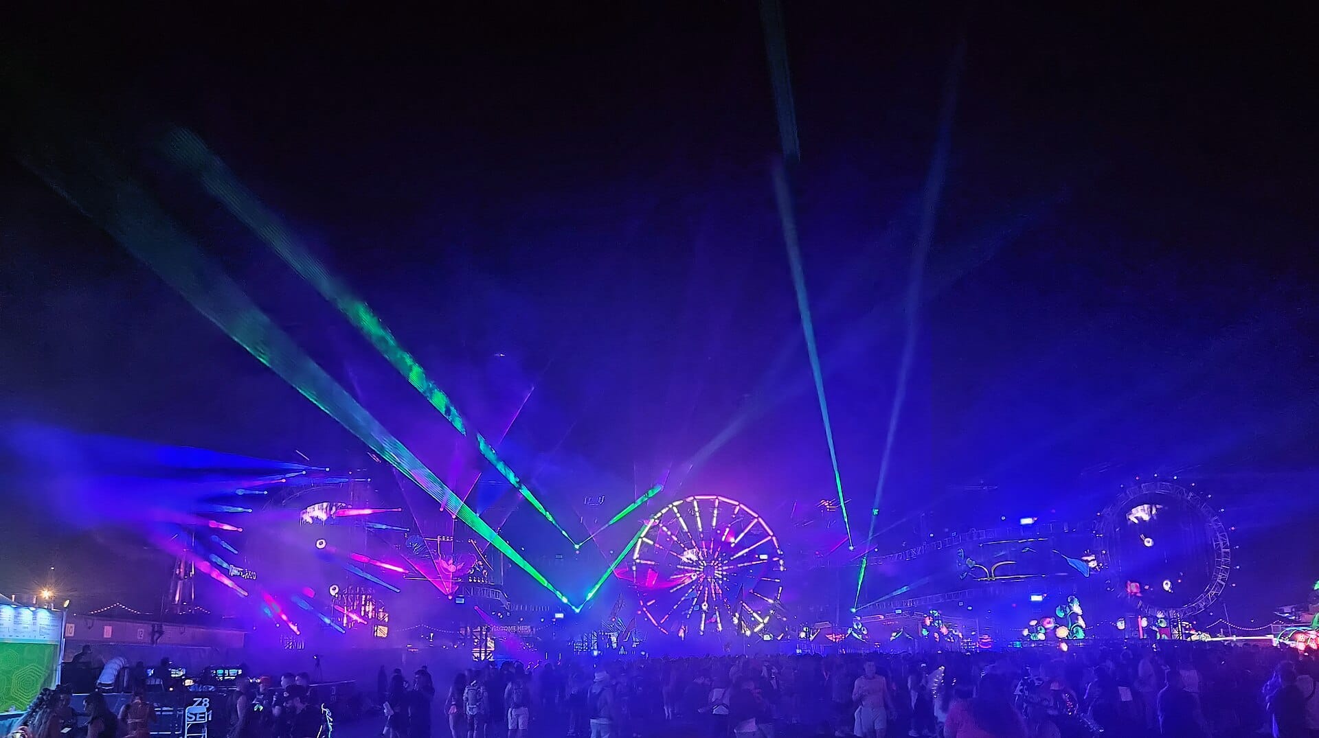 A ferris wheel lit up at night over the crowd at an Electric Daisy Carnival festival, the kind of scene EDC Korea 2026 brings to Incheon