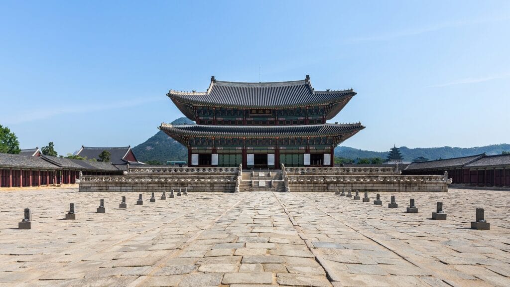 Gyeongbokgung Palace Guide: Tickets, Hours & Tips (2026) Geunjeongjeon, the main throne hall of Gyeongbokgung Palace, under a blue sky in Seoul
