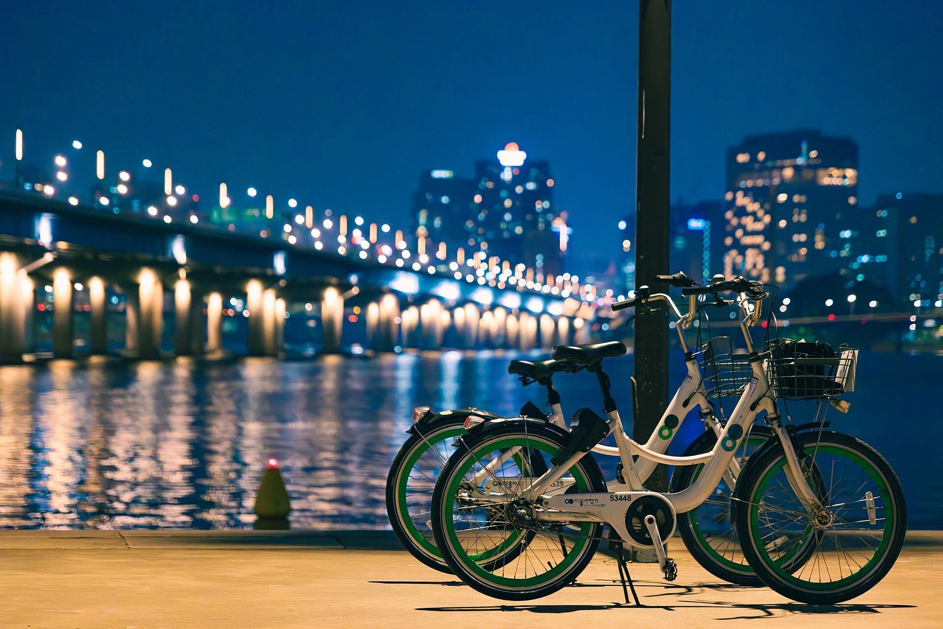 The Han River in Seoul: Parks, Picnics & Cruises (2026) Cyclists along the Han River in Seoul at night