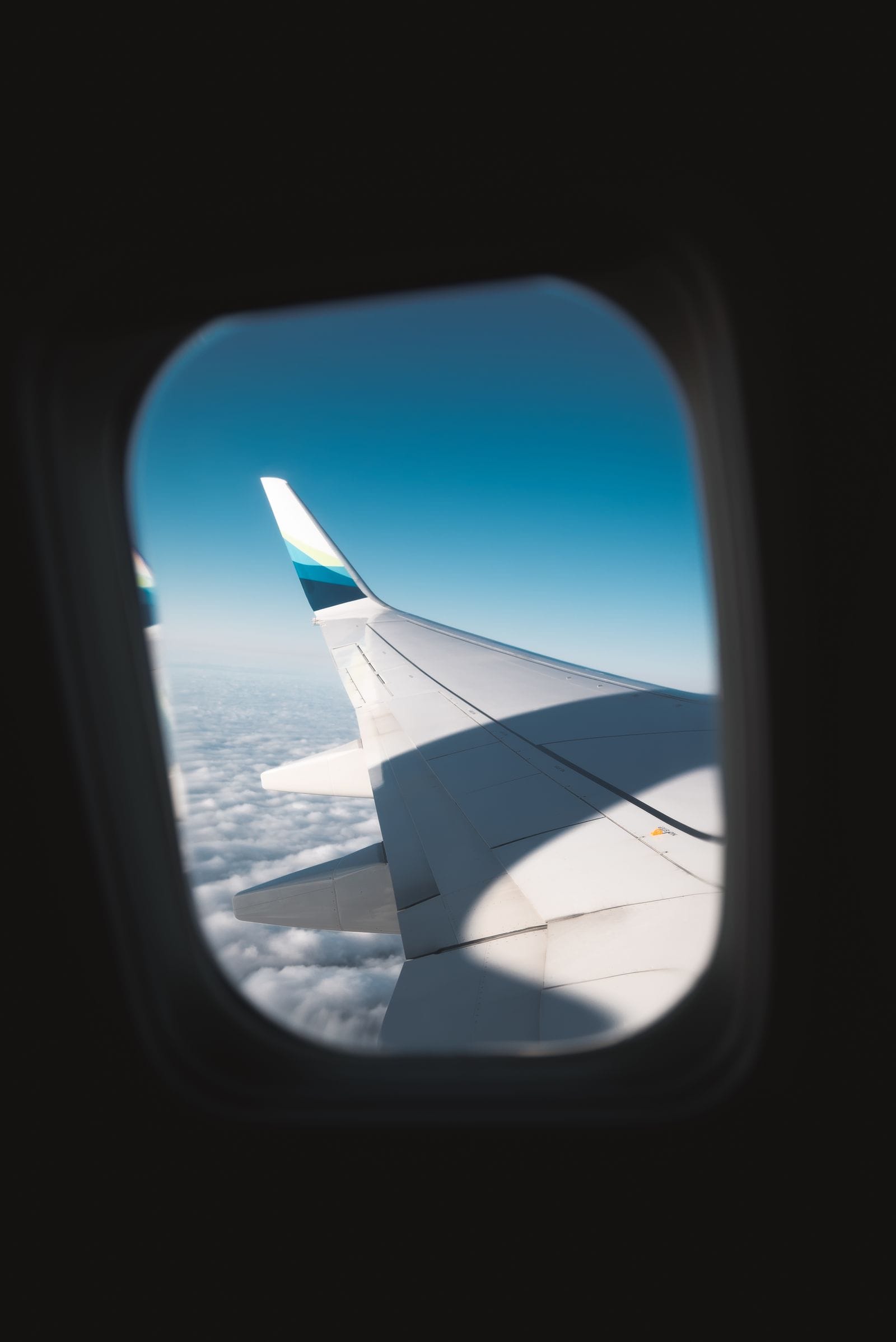 Incheon Airport New Routes 2026: New Airlines, More China Flights An airplane wing above clouds during a long-haul flight to Korea