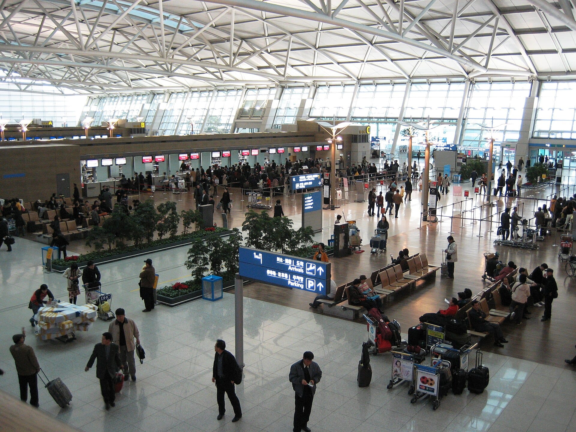 Check-in counters at Incheon International Airport, where currency exchange and WOWPASS kiosks are also located