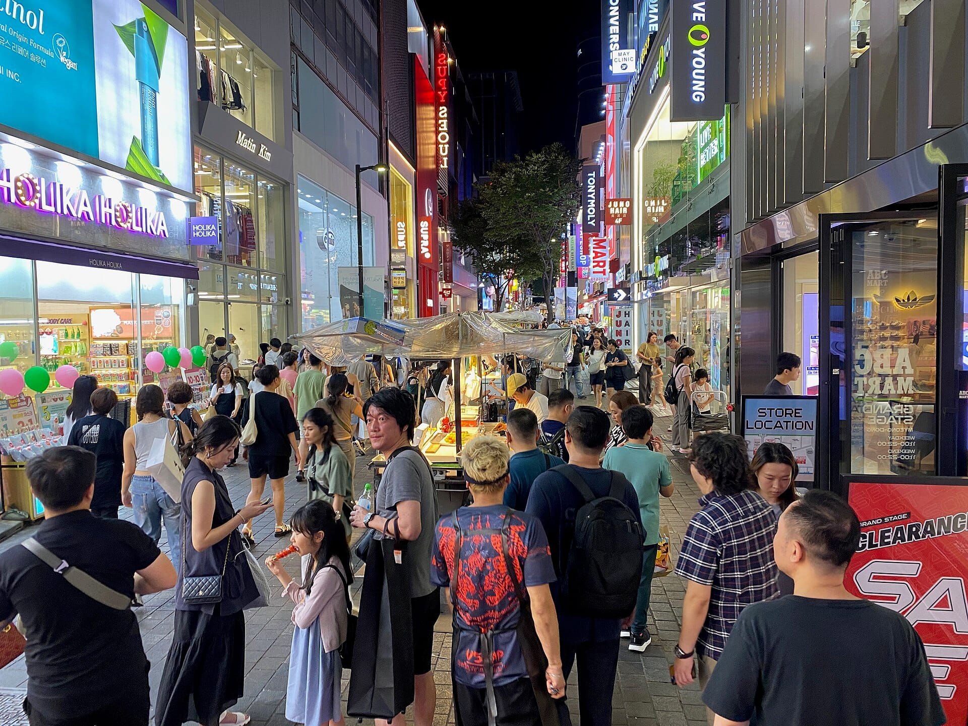 Seoul Neighborhoods Guide: Which Area Is Right for You? (2026) Crowds and street-food stalls on the Myeongdong shopping street in Seoul at night