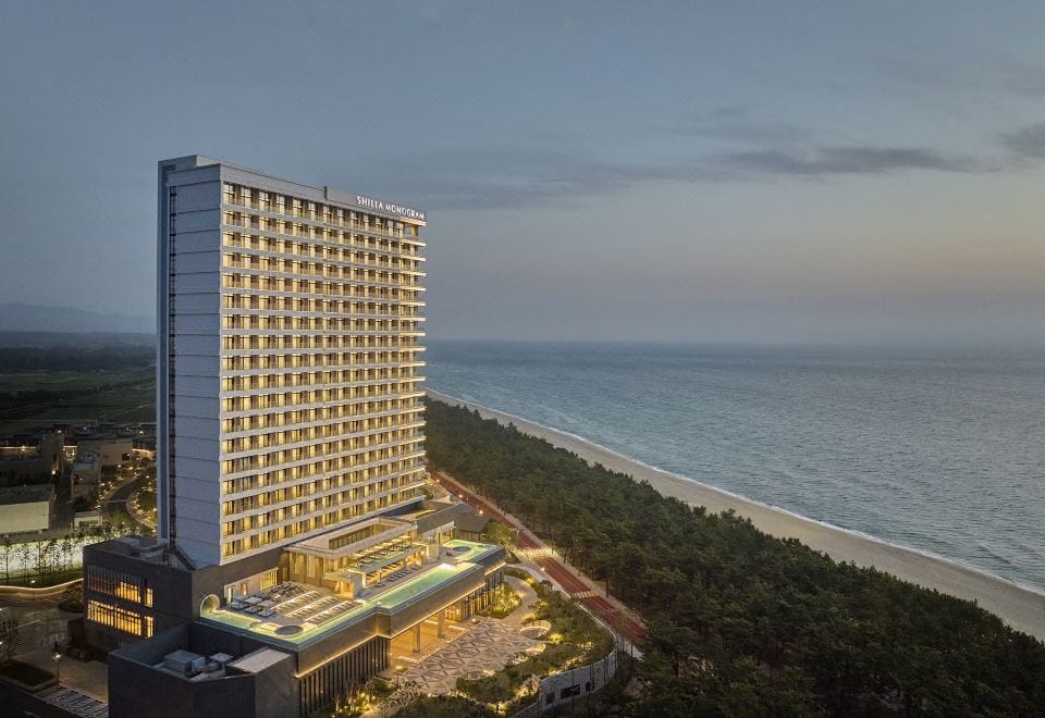 Where to Stay in Gangneung: Best Areas & Hotels for Every Trip (2026) A room with ocean and pine forest views at Shillamonogram Gangneung Hotel near Anmok Beach