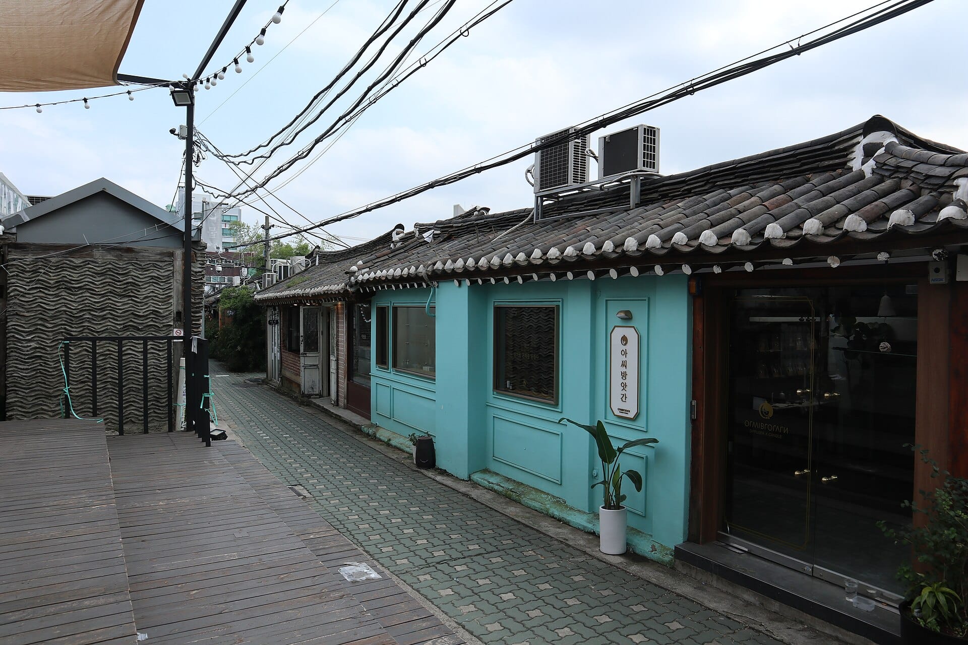 Visitors walking past small hanok shopfronts in the maze of alleys in Ikseondong, Seoul
