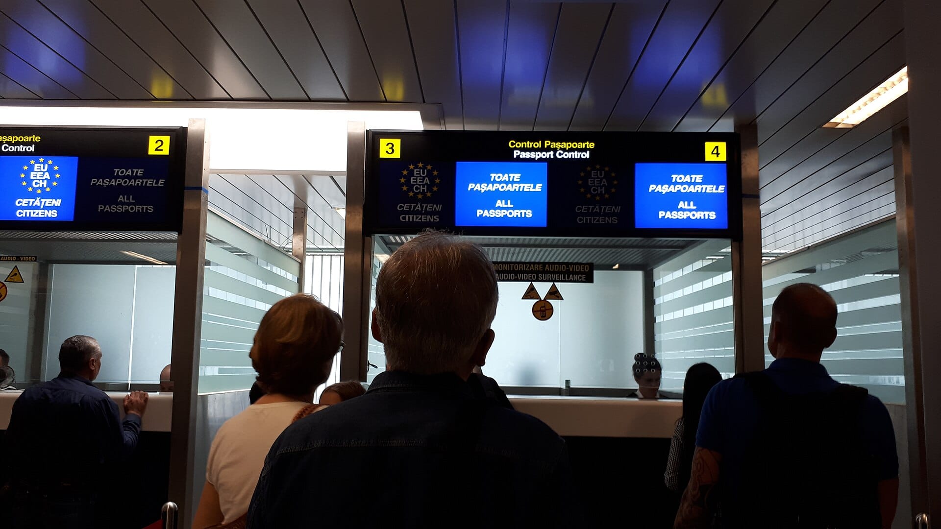Incheon Airport Immigration Wait Times: Why Lines Hit 80 Minutes This Summer (2026) Travelers passing through a staffed airport passport control checkpoint, the kind of counter running short-handed at Incheon this summer