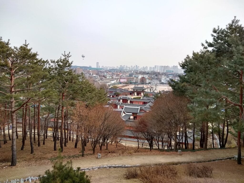 Suwon Hwaseong Fortress Day Trip from Seoul: Complete 2026 Guide The stone rampart of Hwaseong Fortress winding along a hillside in Suwon, South Korea