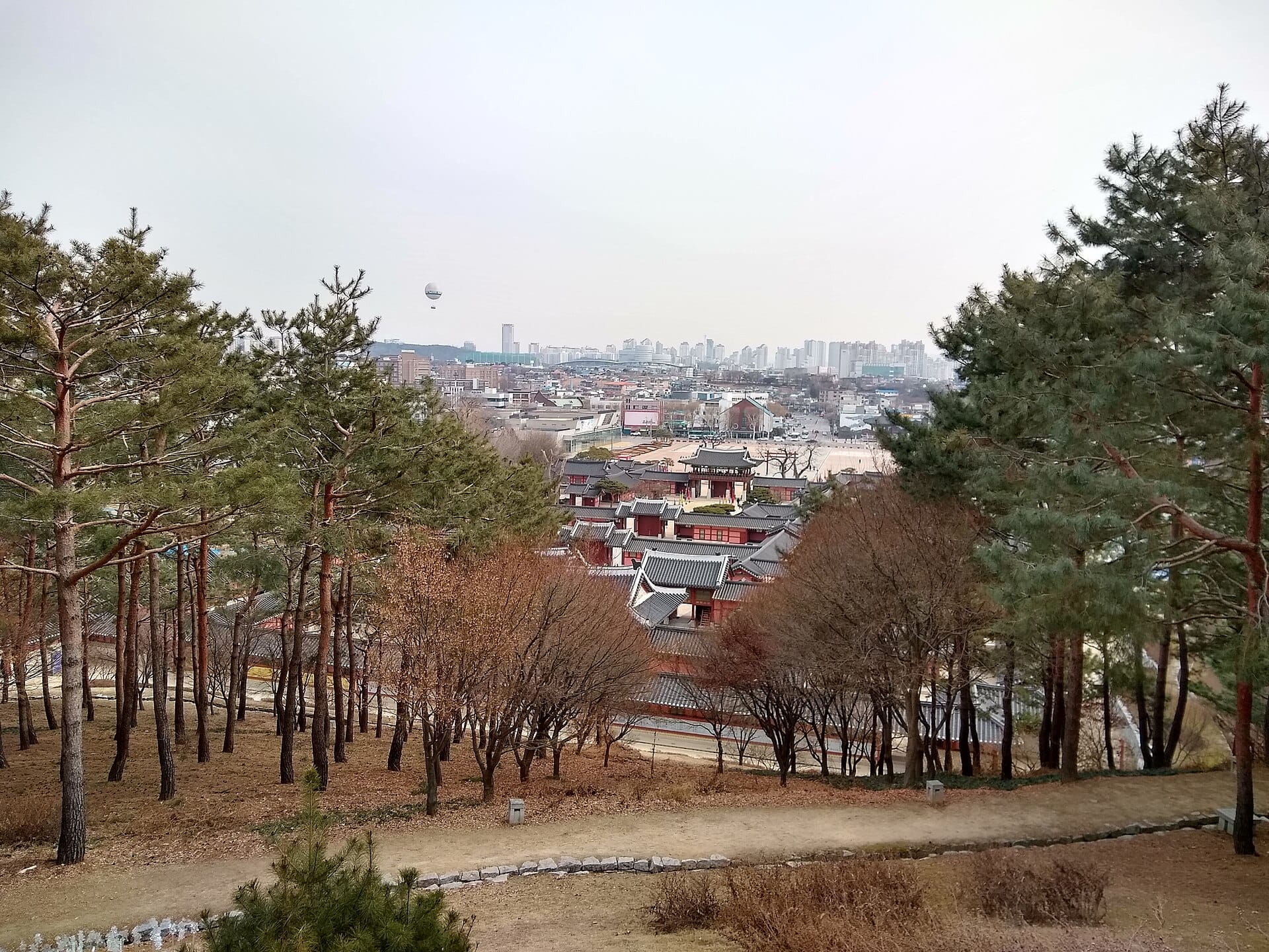 Suwon Hwaseong Fortress Day Trip from Seoul: Complete 2026 Guide The stone rampart of Hwaseong Fortress winding along a hillside in Suwon, South Korea