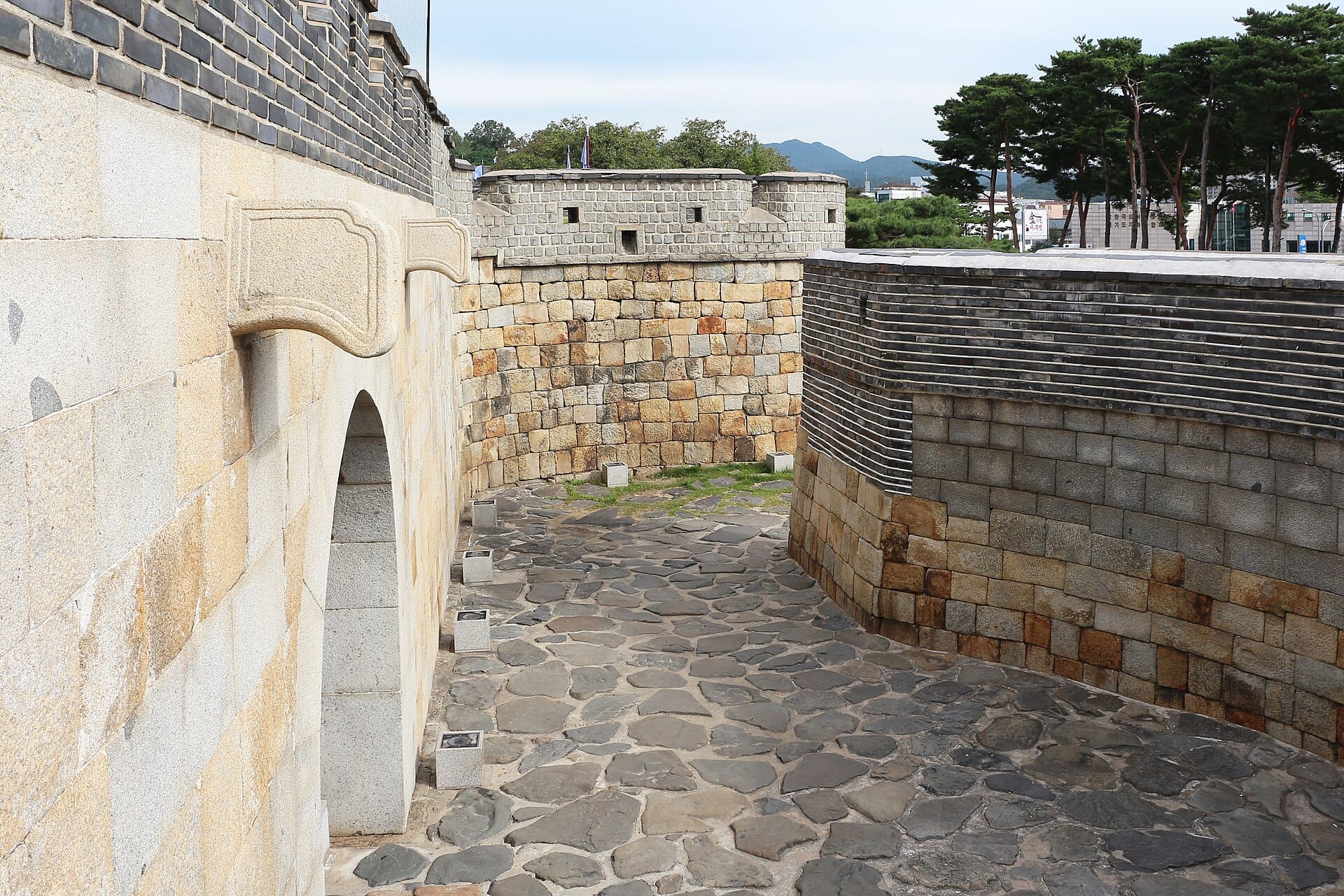 Suwon Hwaseong Fortress Day Trip from Seoul: Complete 2026 Guide Visitors walking the wall walk atop Hwaseong Fortress in Suwon