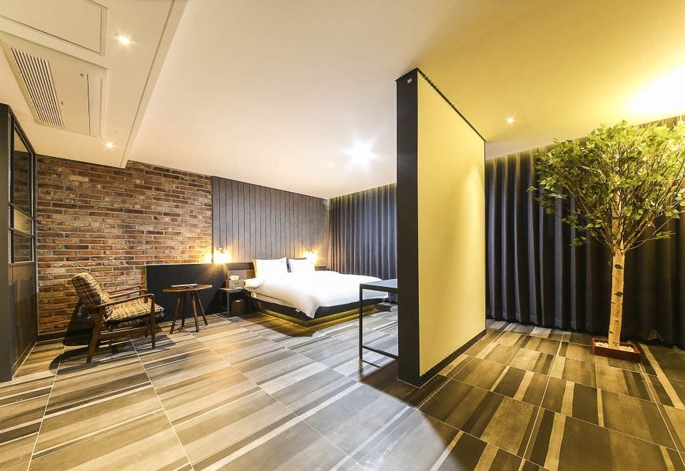 Where to Stay in Yeosu: Best Areas & Hotels for Every Trip (2026) A guest room with a soaking tub at K Boutique Hotel in downtown Yeosu