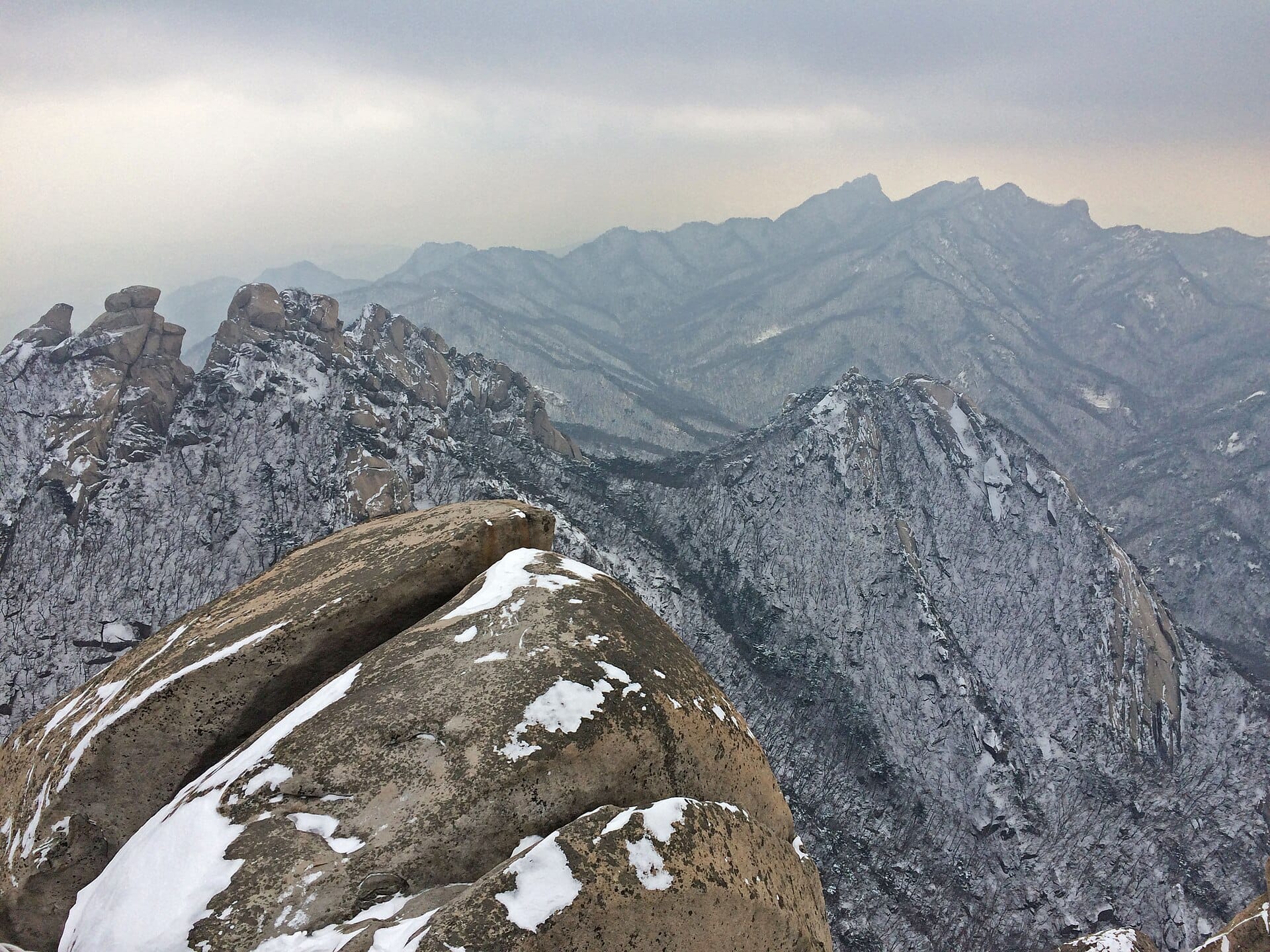 Panoramic view over Seoul and the surrounding mountains from the summit of Baegundae Peak