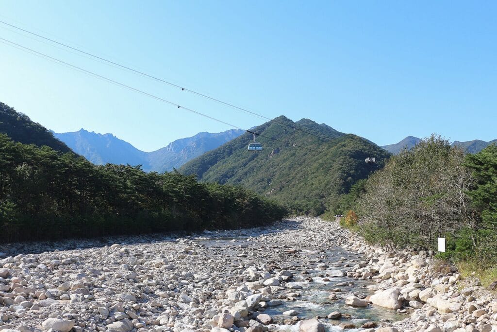 Cable car climbing above the granite ridgelines of Seoraksan National Park, the first place in Korea where autumn foliage peaks each year