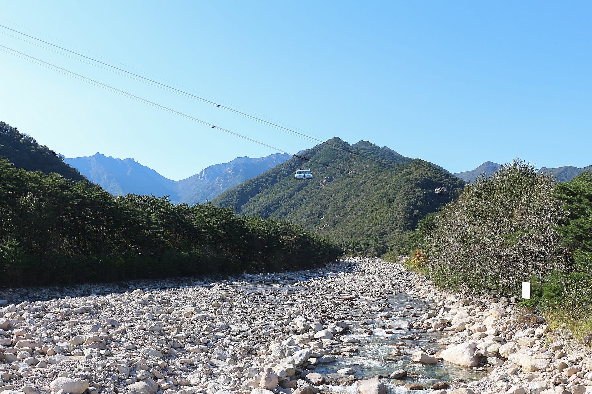Cable car climbing above the granite ridgelines of Seoraksan National Park, the first place in Korea where autumn foliage peaks each year