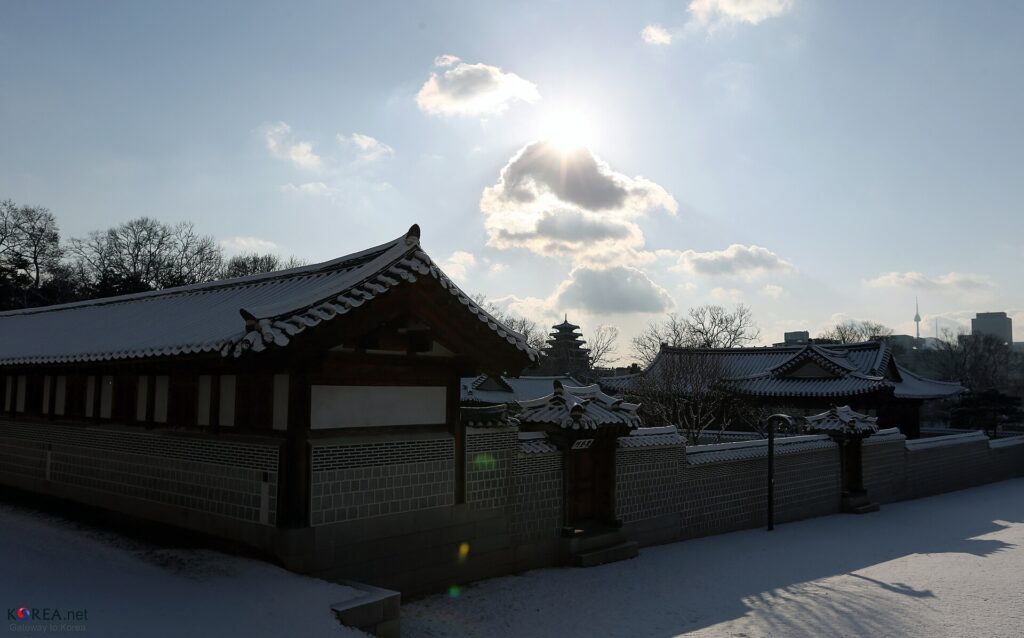 Snow covering the rooftops and courtyard of Gyeongbokgung Palace in Seoul in winter